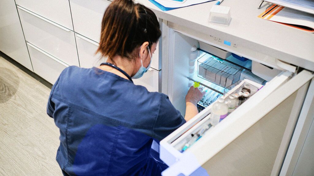 A nurse putting away antibiotic medication that can cause diarrhea -2.