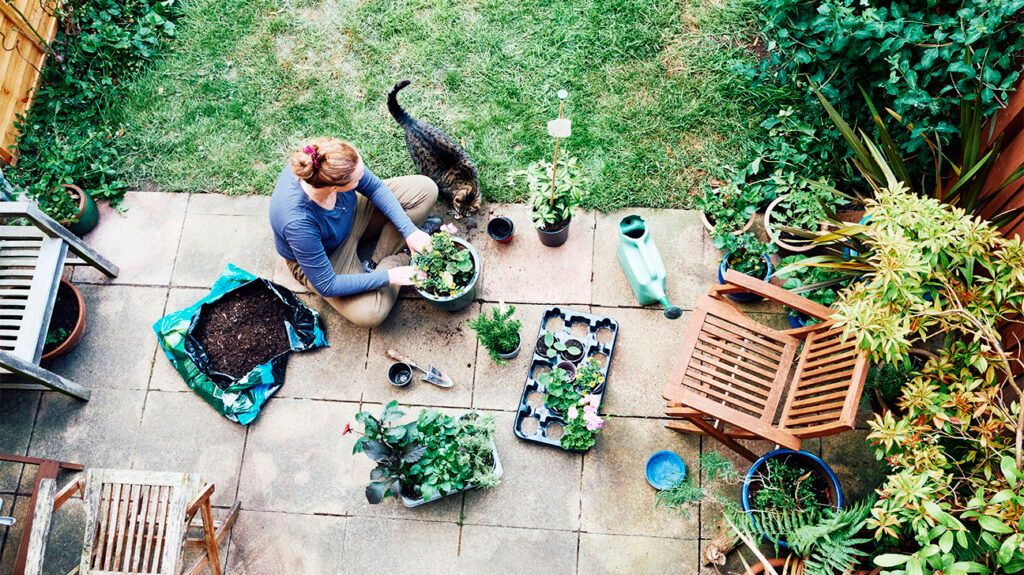A woman sitting in her garden and potting plants to release dopamine -2.