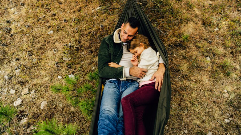 A parent and their child in a hammock -1.