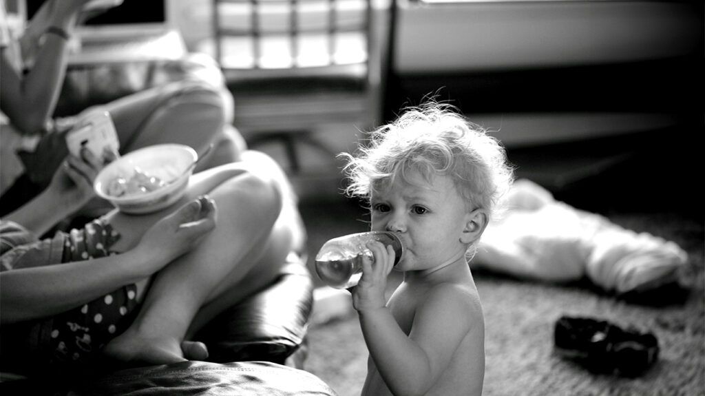 A baby drinking from a bottle.