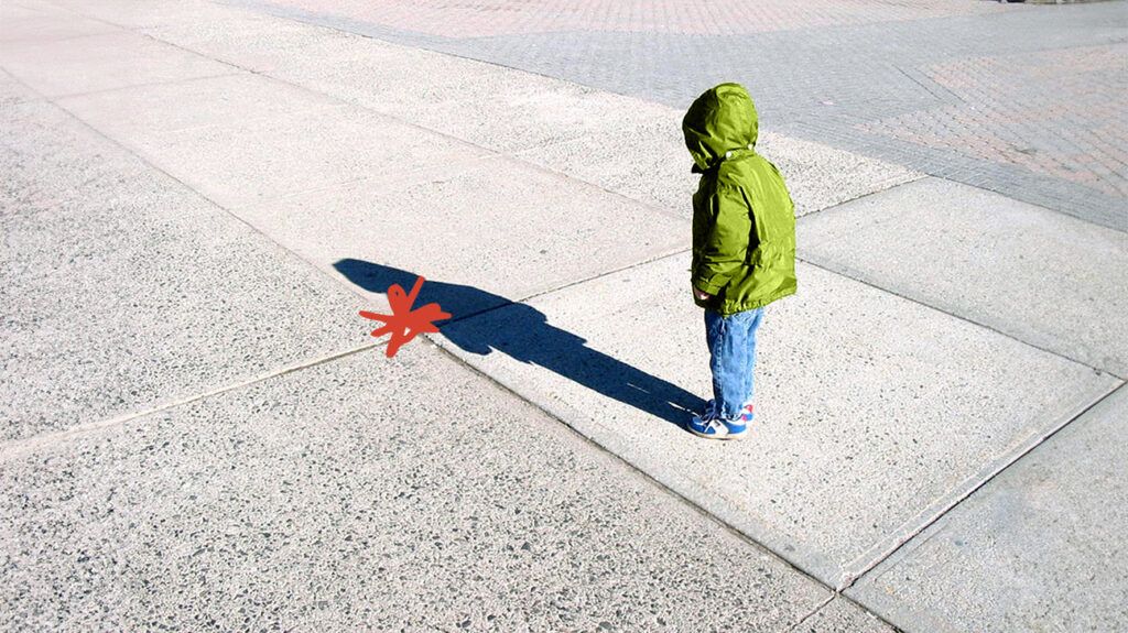 A child looking at their shadow