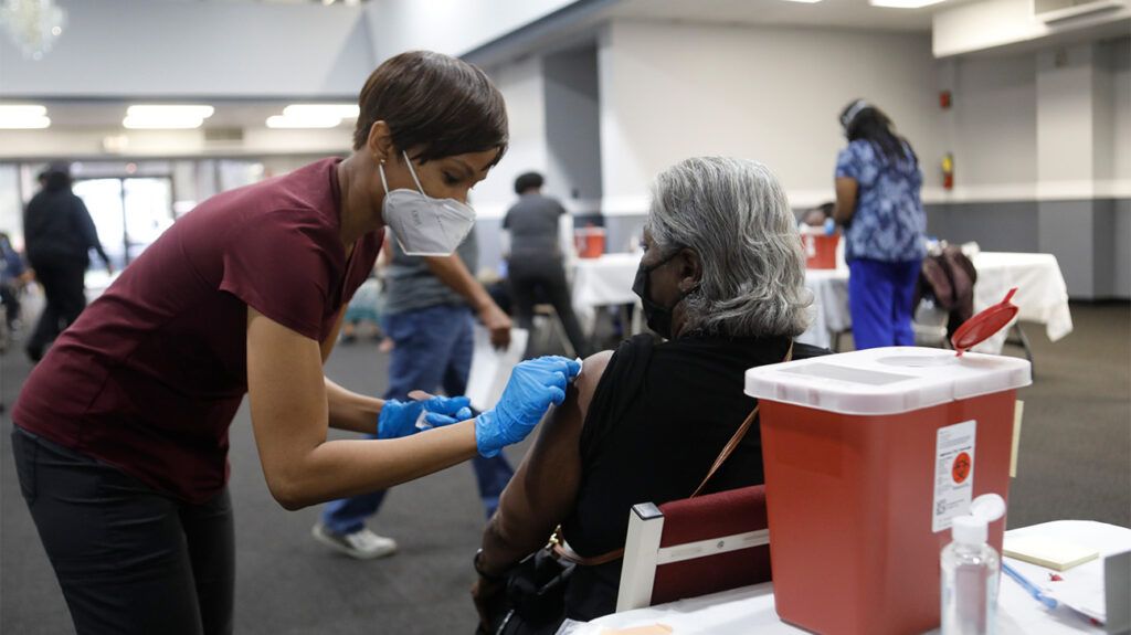 A doctor giving a Black person a vaccination.-1