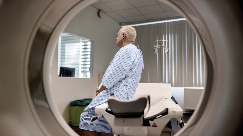 a patient is sat next to a scanner