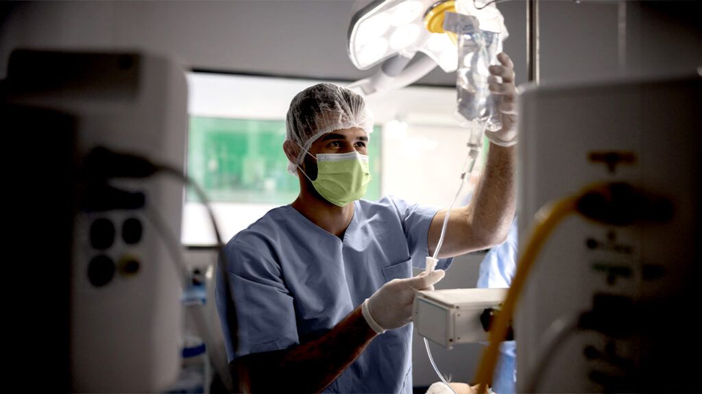 A surgeon looking at a monitor as a part of monitored anesthesia care -1.