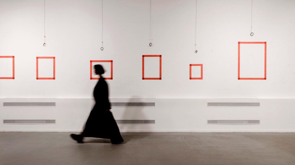 Defocused woman walking in exhibition art hall