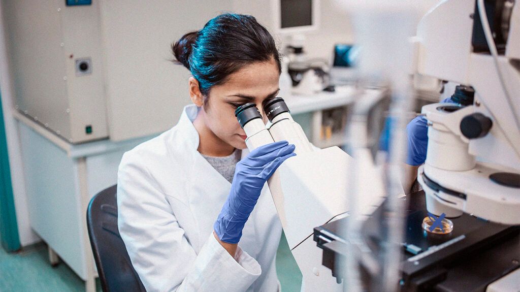 A female scientist looking through a microscope -2.