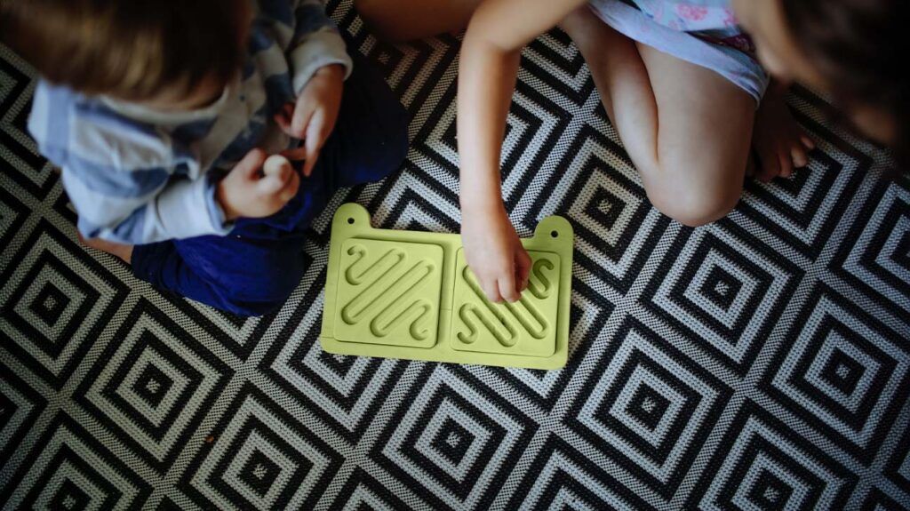 Two children playing a game on the floor -1.
