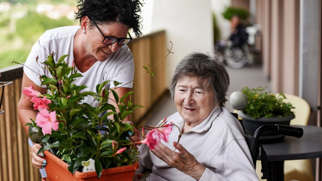 An older adult with dementia speaking with a caregiver -1.