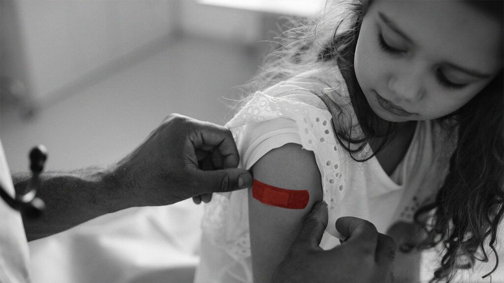 A doctor putting a plaster on a child who received the hepatitis A vaccine -2.