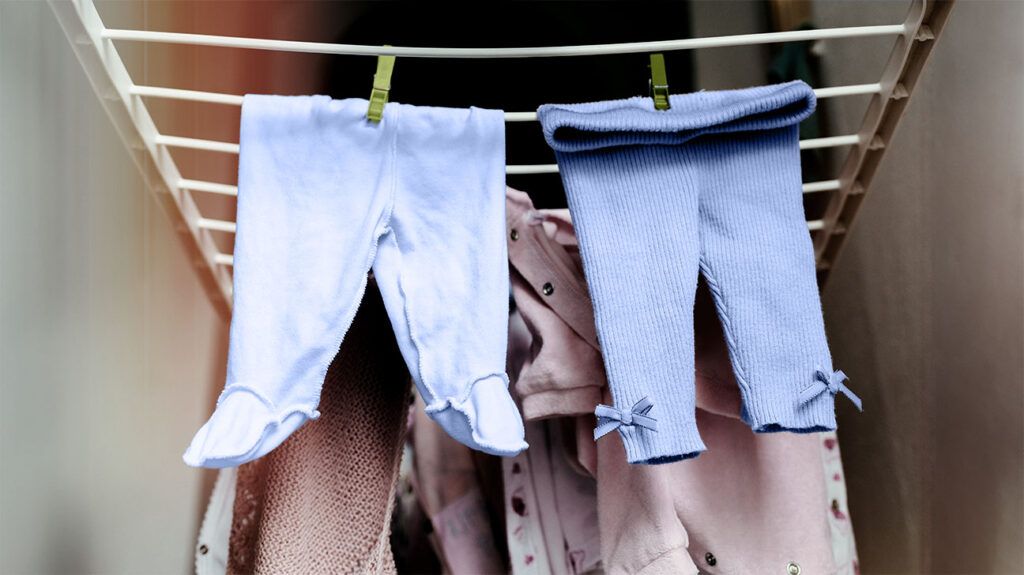 Leggings for babies hung on a clothes airer to dry.