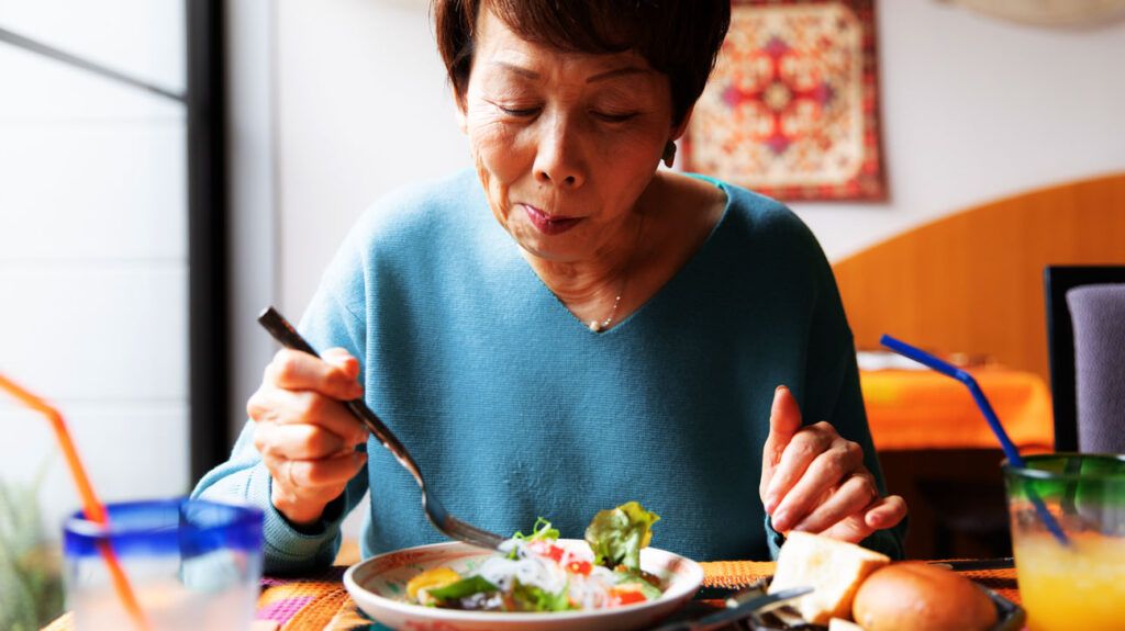 A woman with dementia eating some food -1.