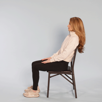 Female in a chair demonstrating a marionette stretch