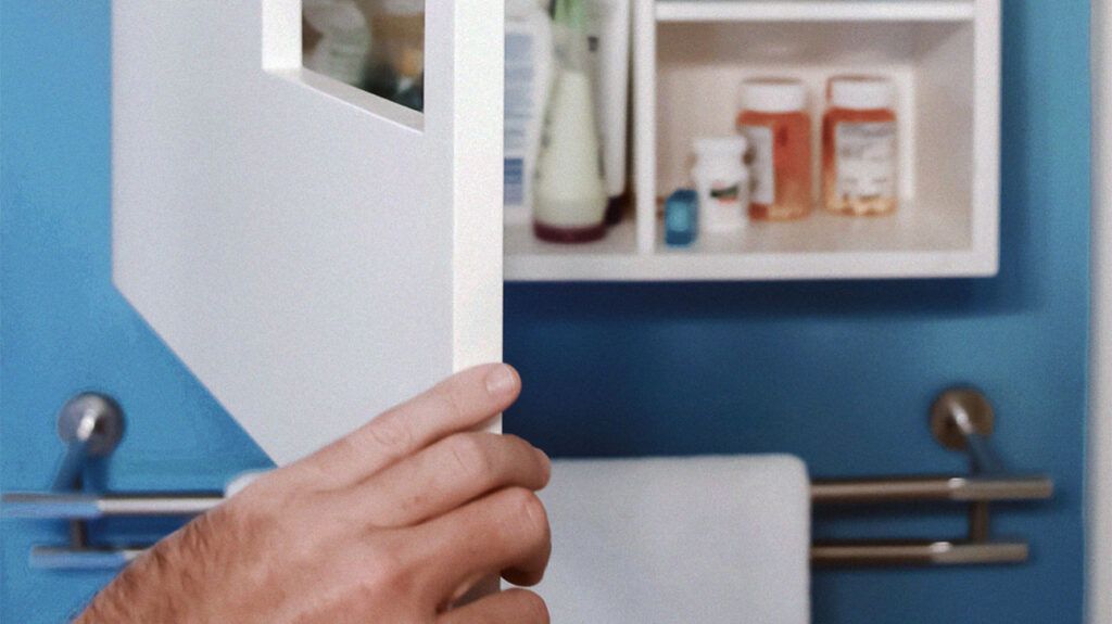 A person opening a medicine cabinet full of different ADHD medications