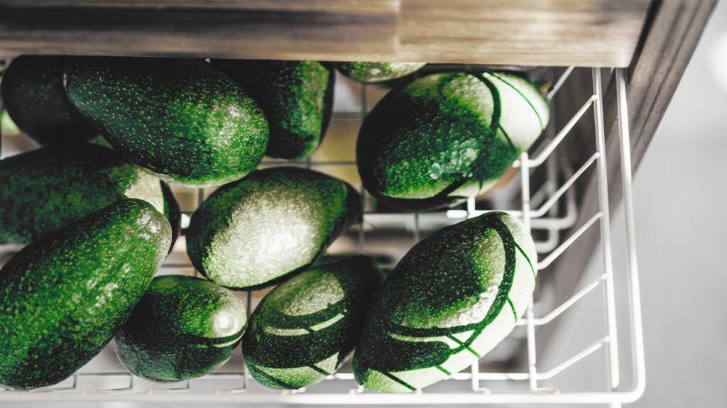 photo of avocados in a white wire basket