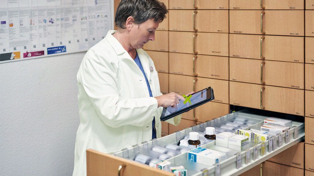 Pharmacist looking in a medication drawer