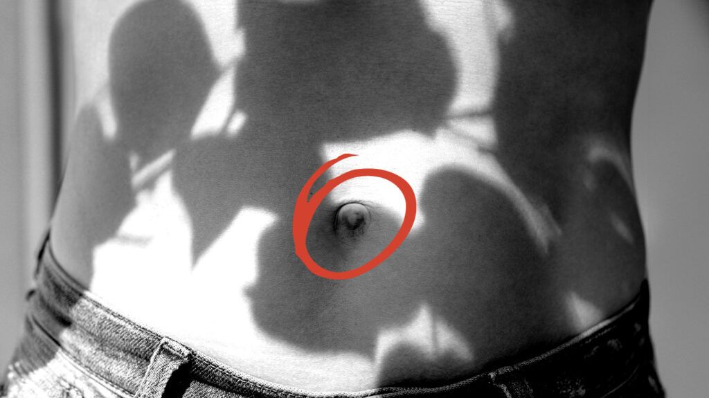 Close up of a bellybutton with shadows.