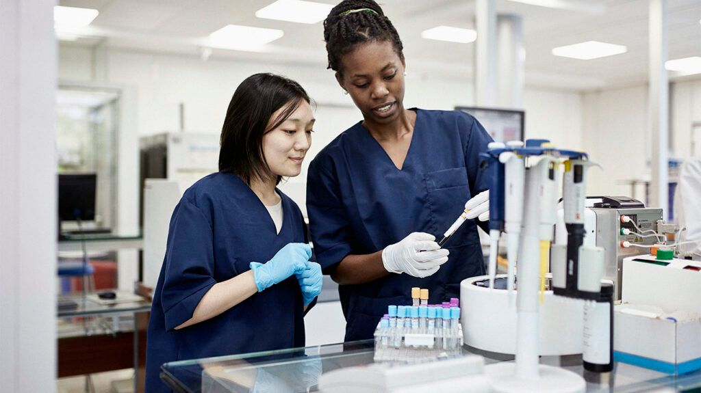 Healthcare professionals with blood test samples in a lab