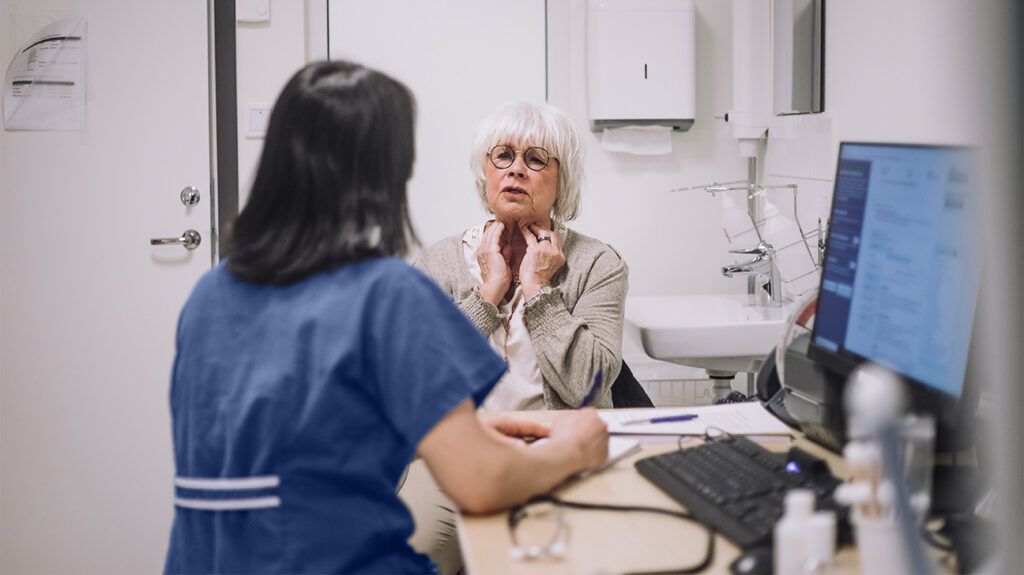 a patient is talking to a doctor in clinic