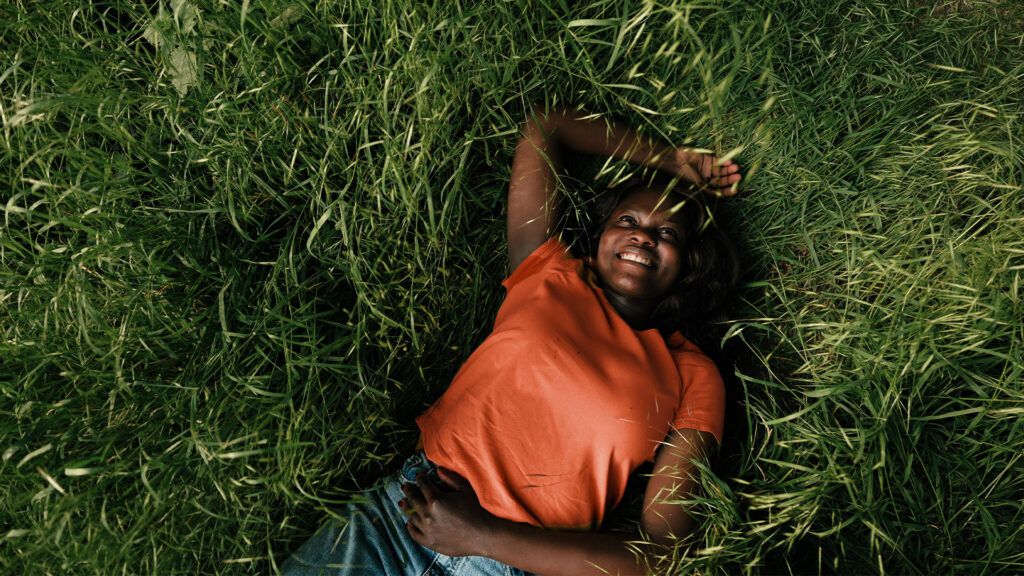 person smiling in the grass