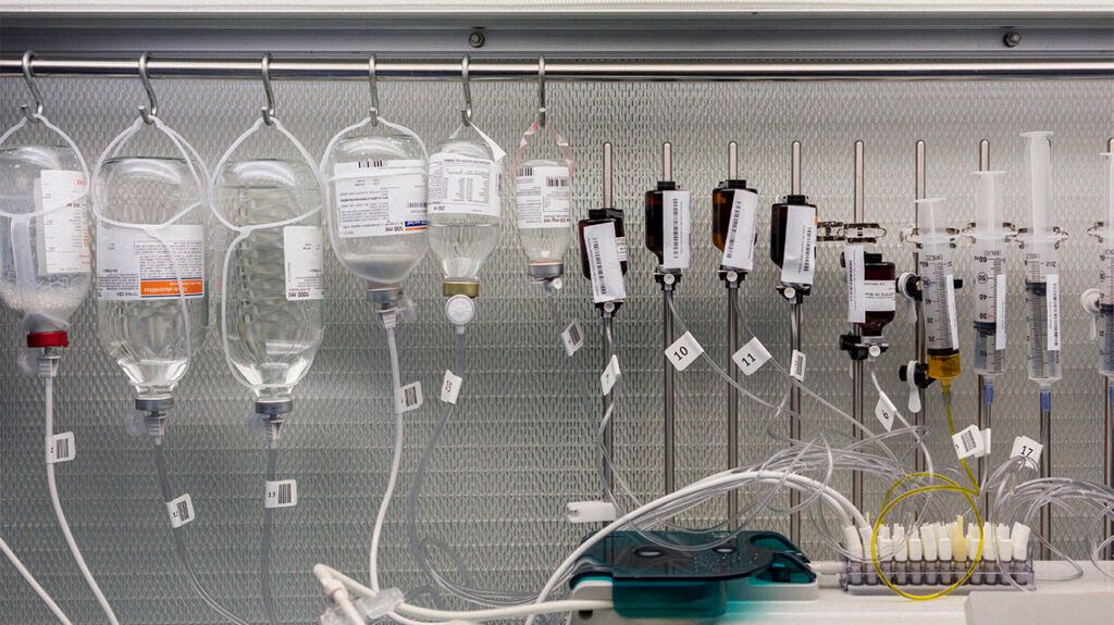 Drips hanging on racks against wall in laboratory