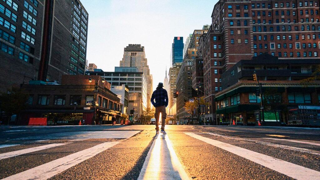 One person crossing a junction in Manhattan at sunrise, New York City