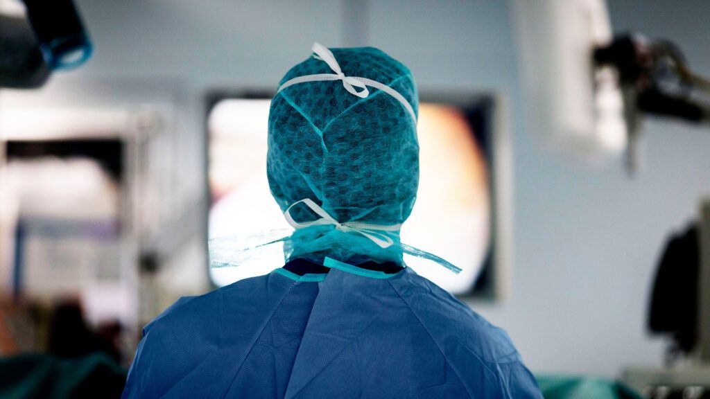 A surgeon stands ready in an operating room