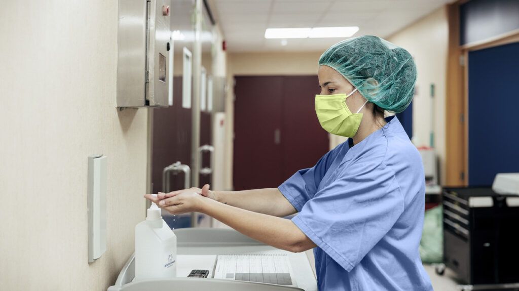 A healthcare professional washing their hands before performing a supraglottoplasty -1.