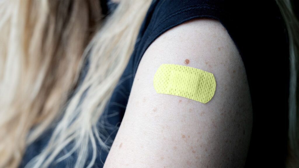 A plaster on someone's arm after a rubella vaccine. -2