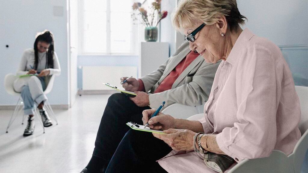Senior patients filling out medical forms