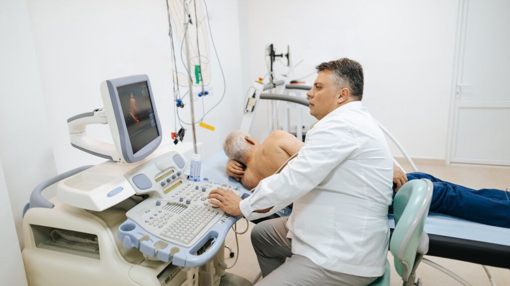 Healthcare professional performing a scan on a person's heart