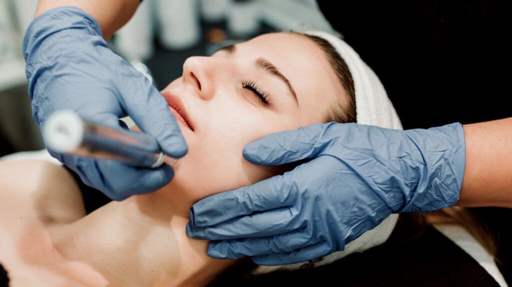A person receiving a microdermabrasion treatment.