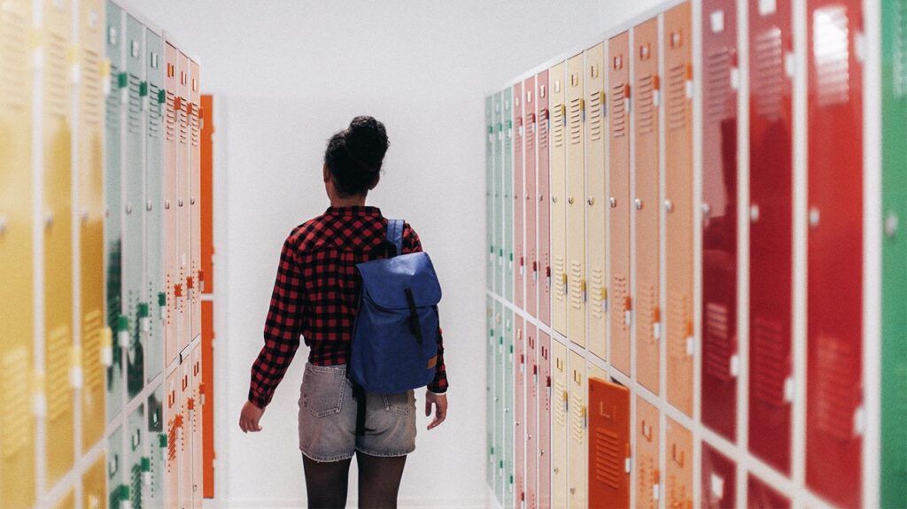 Young female walking through the hall of a school