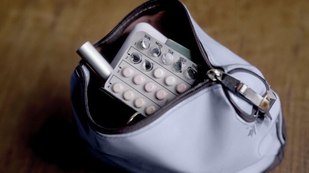 A handbag containing birth control pills. 