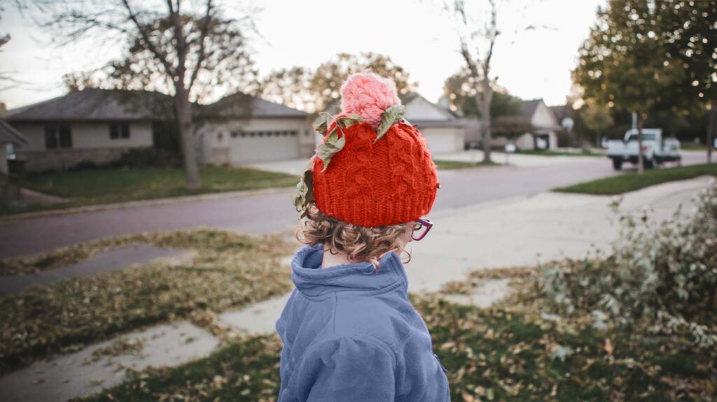 Child in a winter hat looking away from the camera
