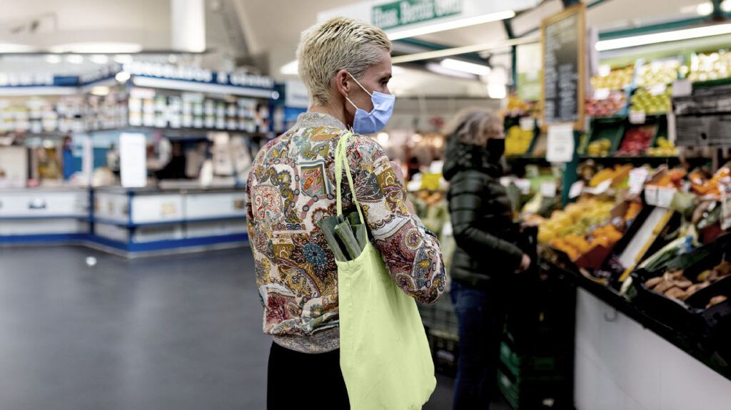 a woman is shopping in a supermarket