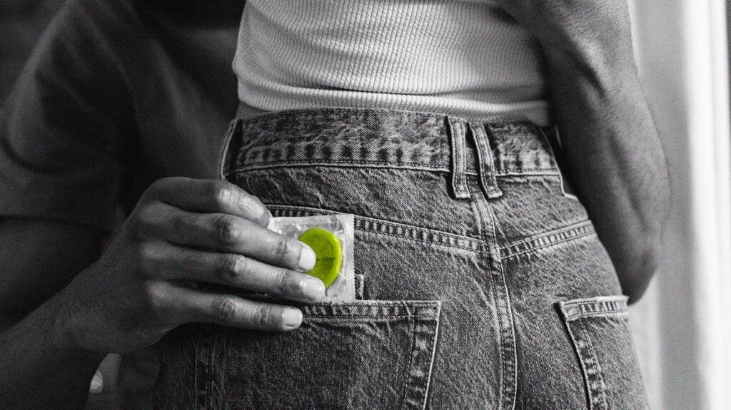 a black and white photo of a condom in someone's back pocket