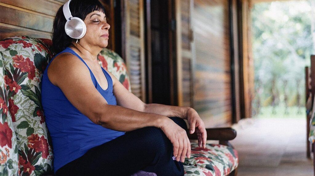 A person is sitting down and wearing headphones.