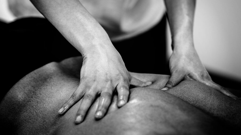 Closeup of a person getting a back massage.