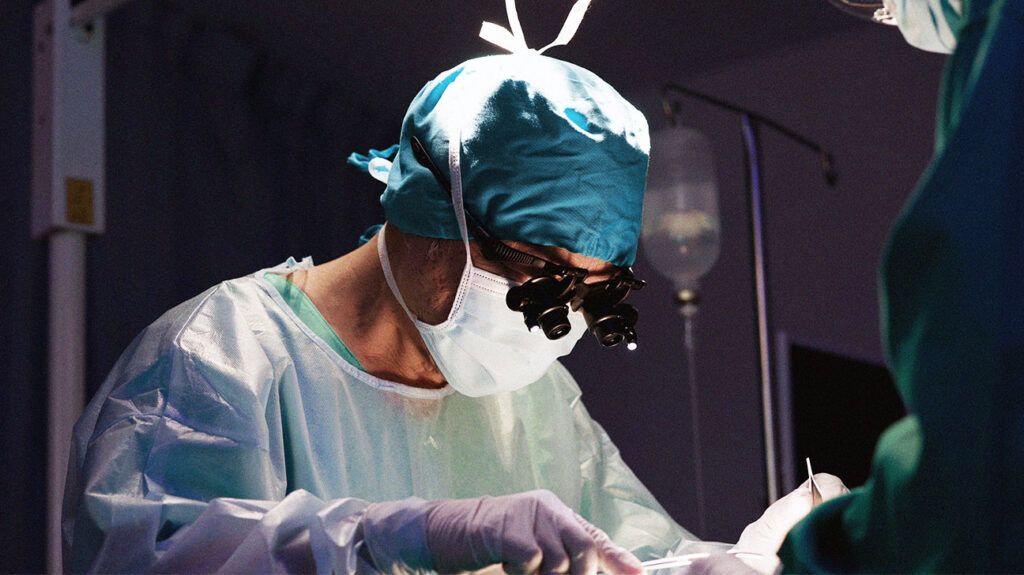 A surgeon performing a retrosigmoid craniotomy 21