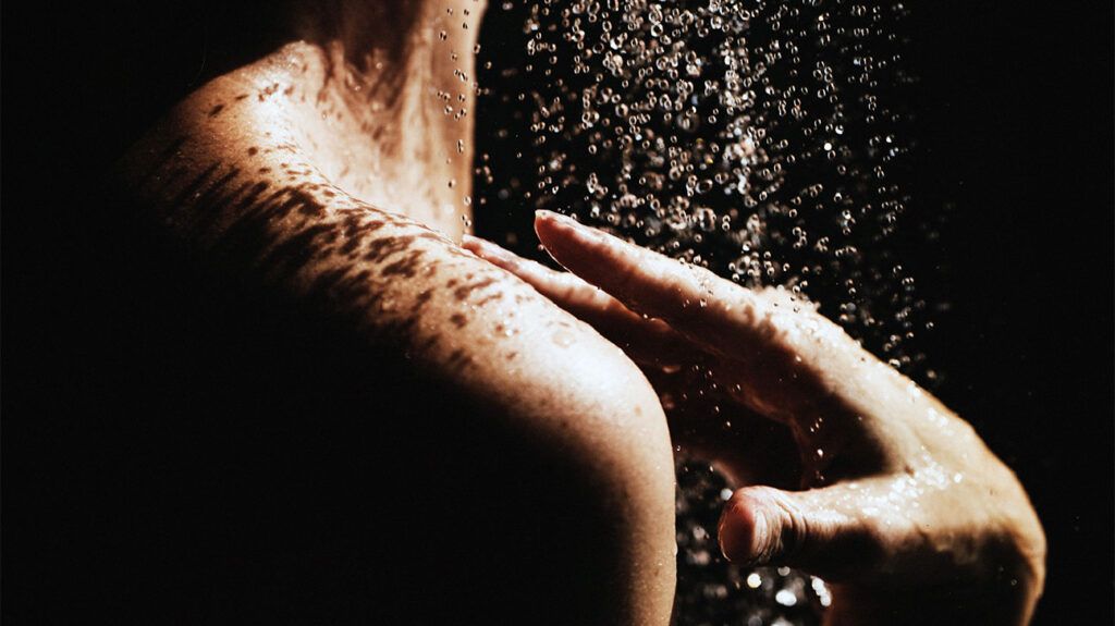 A view of a person's shoulder as they are showering-2.