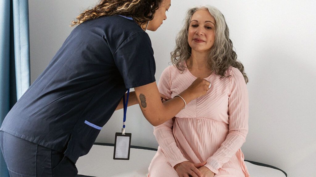 A doctor checking the heartbeat of a person showing symptoms of rheumatic fever -2.
