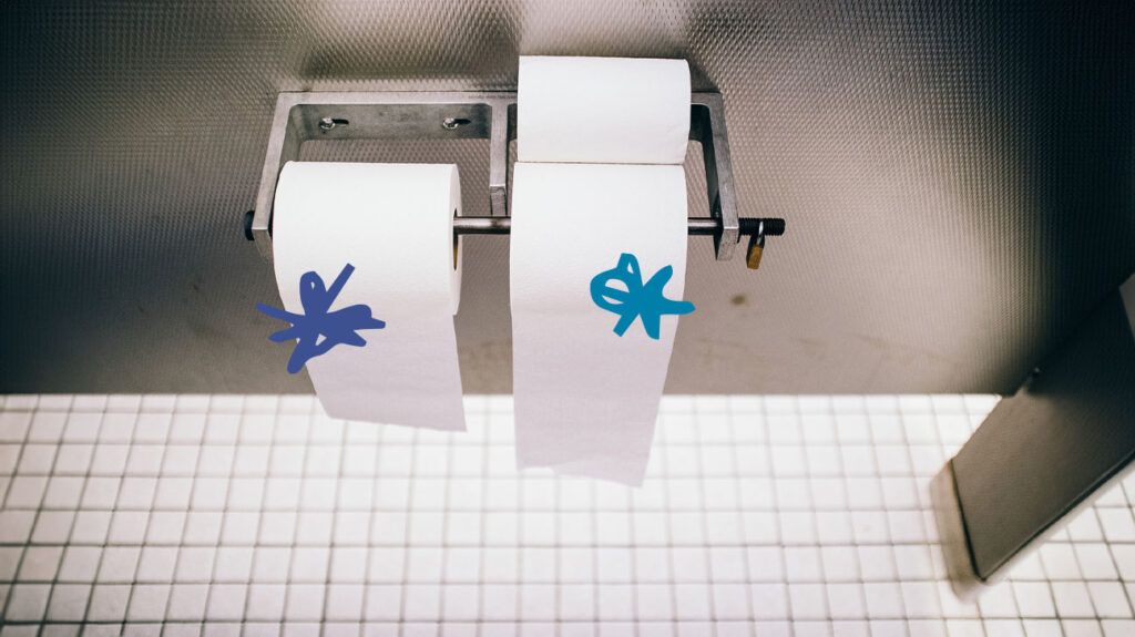 Two rolls of toilet paper with blue squiggles on them -1.