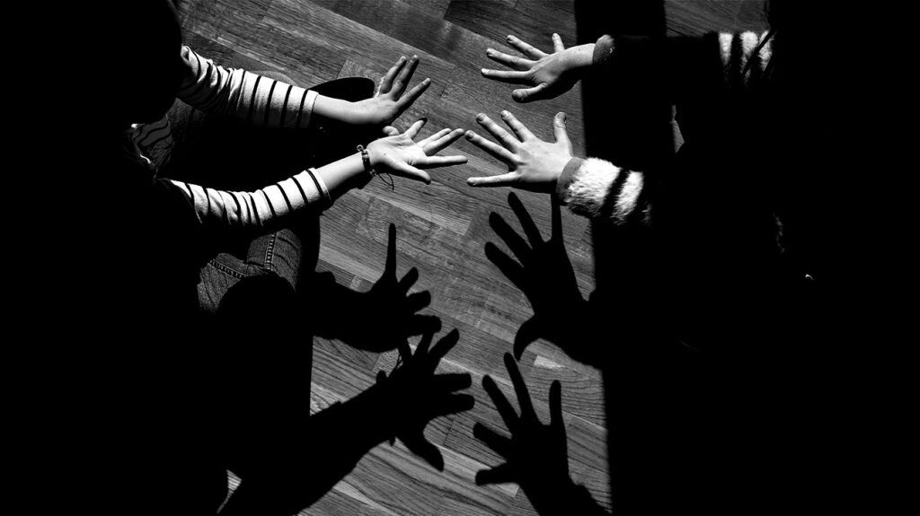 Shadows created by the hands of two young girls