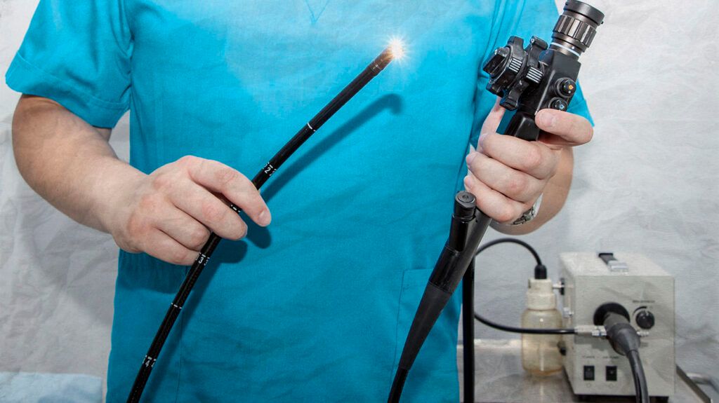 Healthcare professional holding a bronchoscopy tube