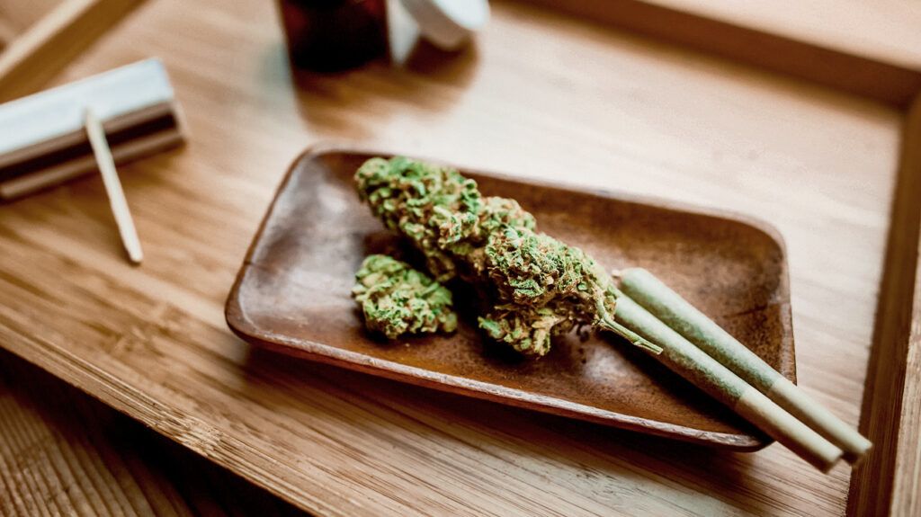 there is a close up of cannabis and rollups on a table