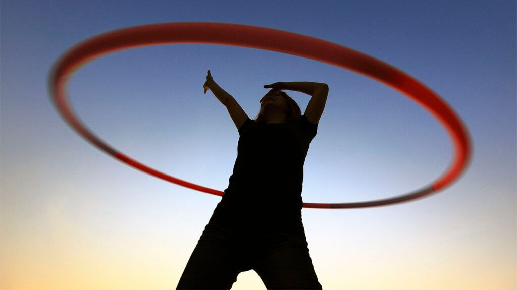 Silhouette of a woman with a hula hoop
