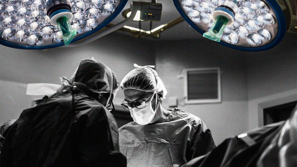 Two surgeons performing an operation. -1