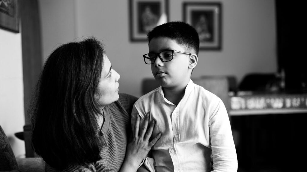 there is a black and white photo of a parent talking to a child