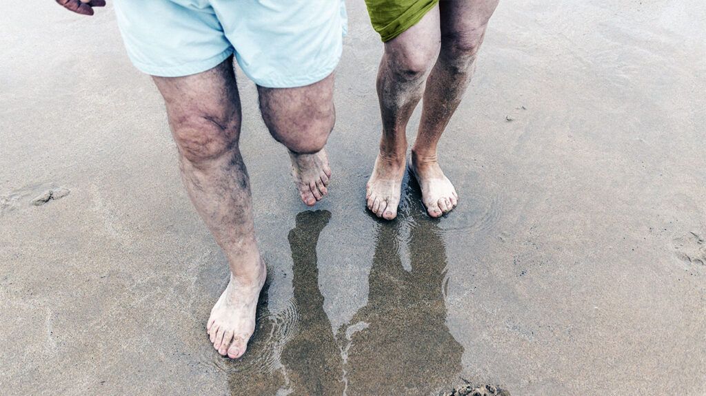 Legs walking on a sandy beach-1