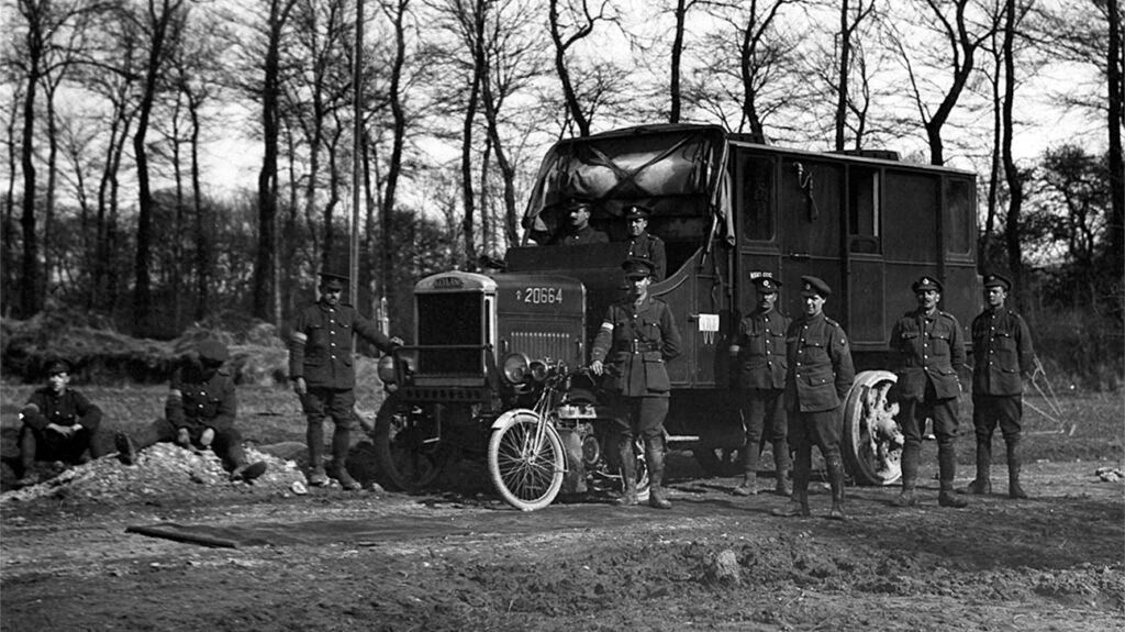 Black and white photo of soldiers next to a truck.